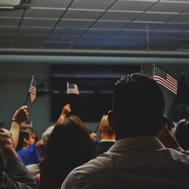 people in a room holding up miniature American flags